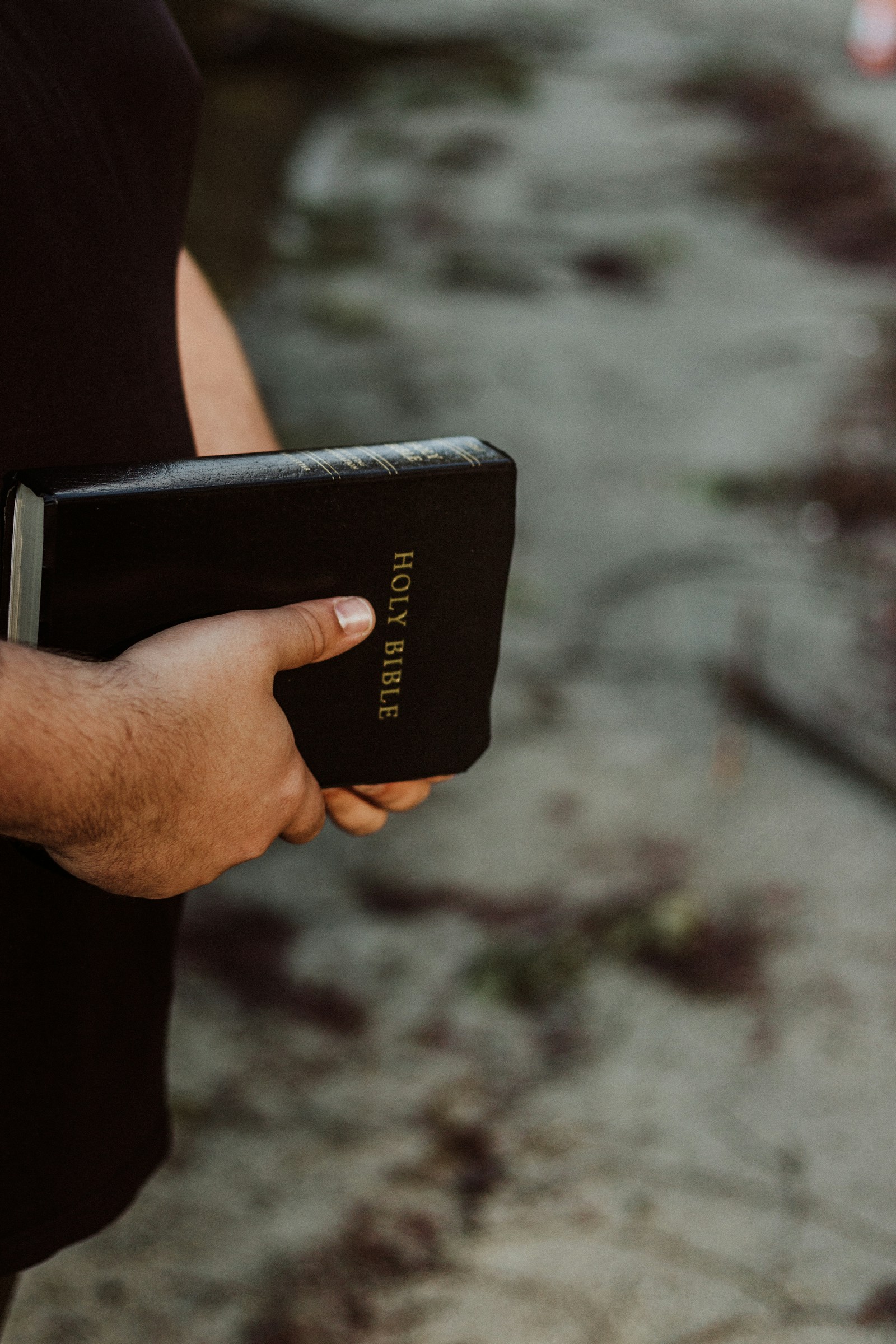 Hands holding a well-used Bible