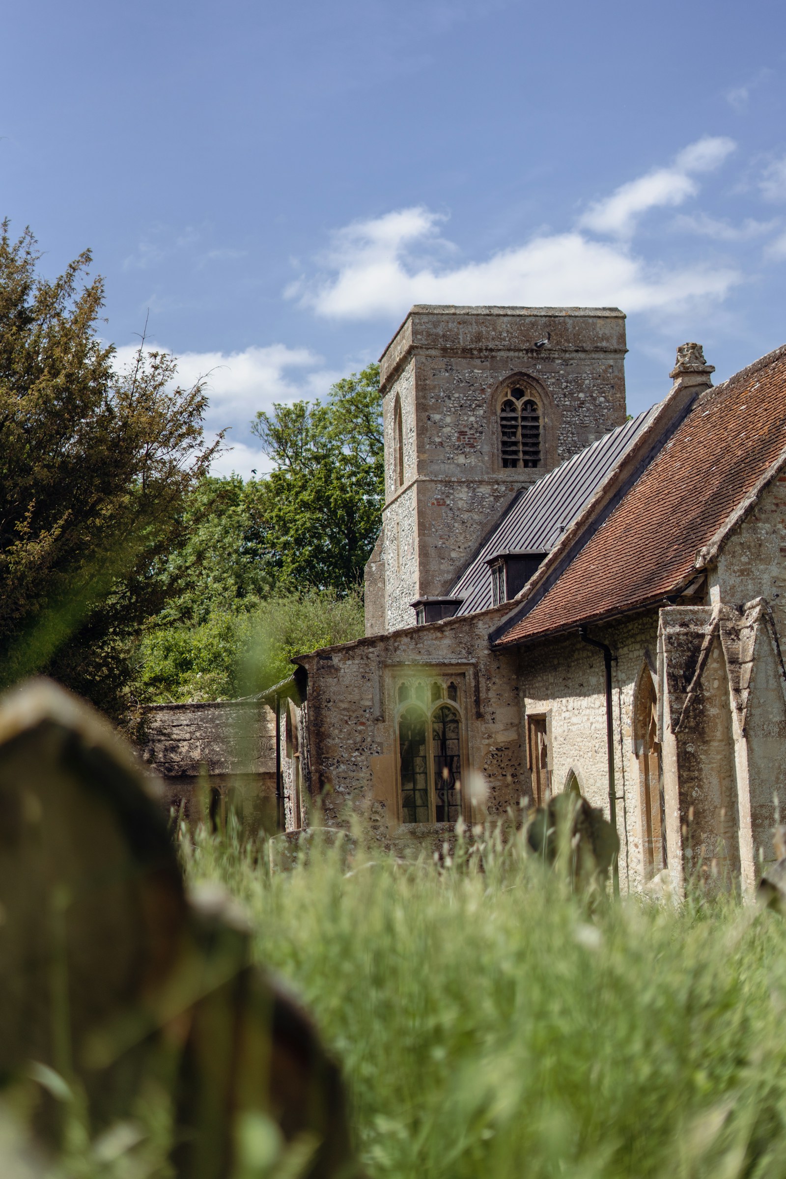 A stone church among trees in the English countryside